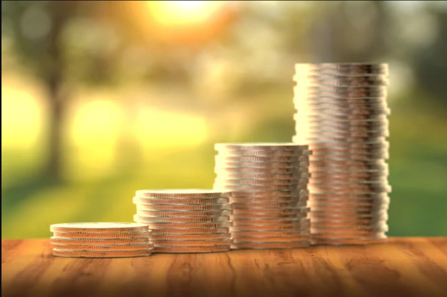 Stacks of coins growing taller to represent ADU grants in California